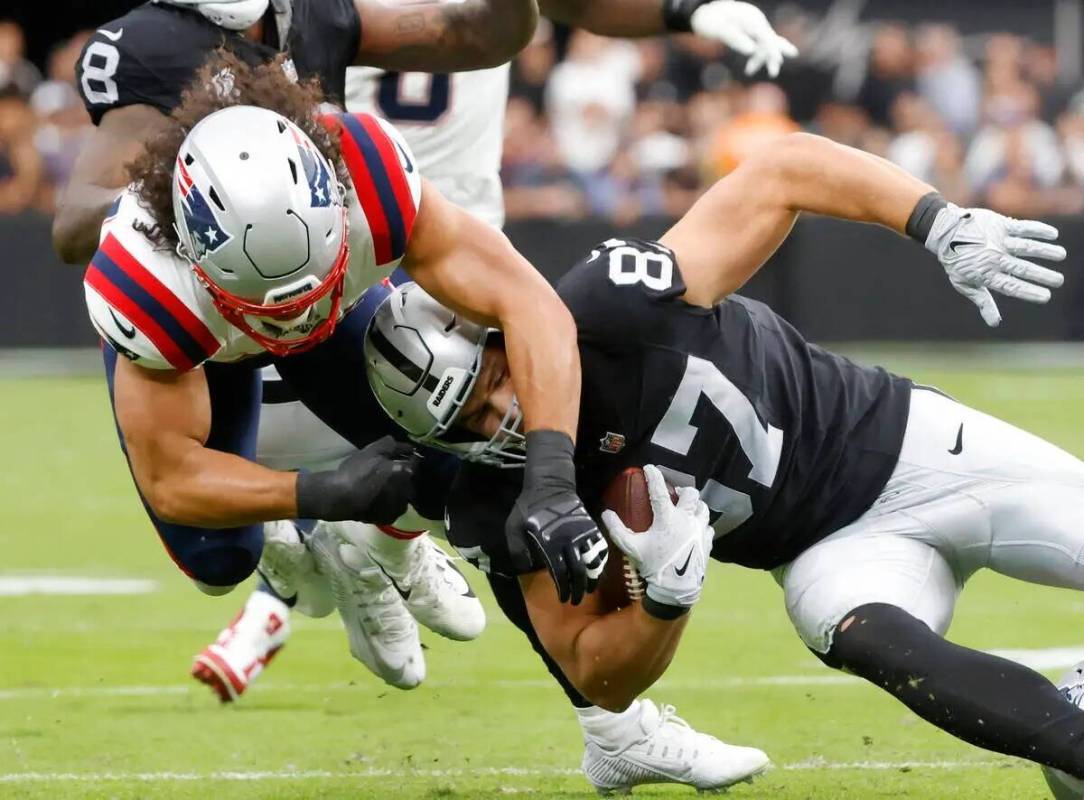 El tight end de los Raiders Michael Mayer (87) es tacleado por el linebacker de los New England ...