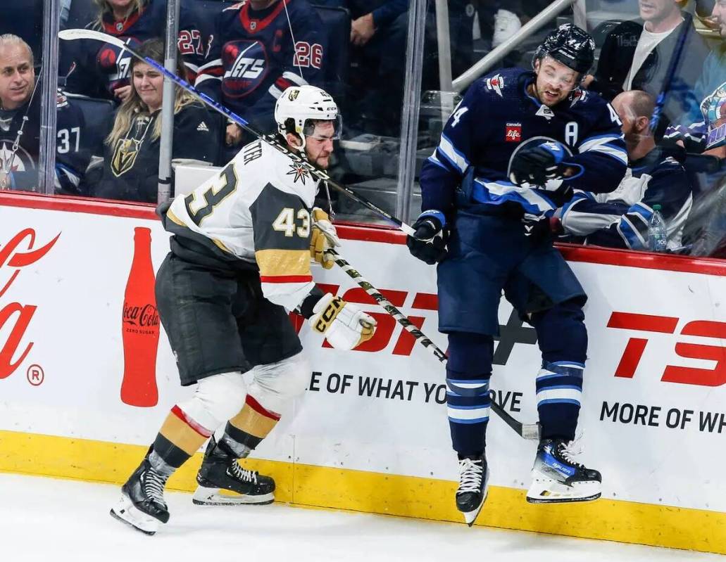 Josh Morrissey (44) de los Winnipeg Jets y Paul Cotter (43) de los Vegas Golden Knights chocan ...