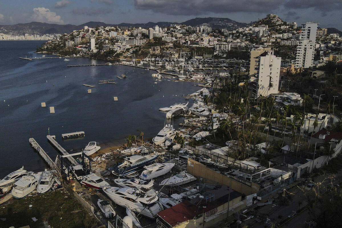 Bomberos y buzos buscan cuerpos cerca de barcos hundidos en un club náutico en Acapulco, Méxi ...