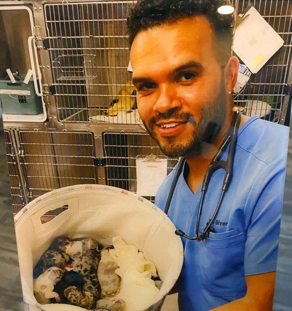 Una fotografía del difunto doctor Aaron Bivens, sosteniendo cachorros recién nacidos, se mues ...
