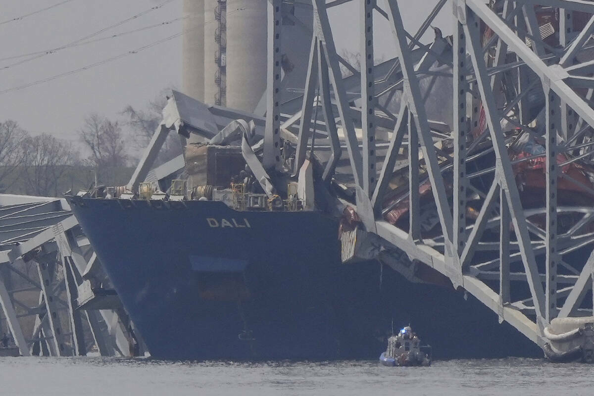 Un buque de carga reposa contra los restos del puente Francis Scott Key, el martes 26 de marzo ...