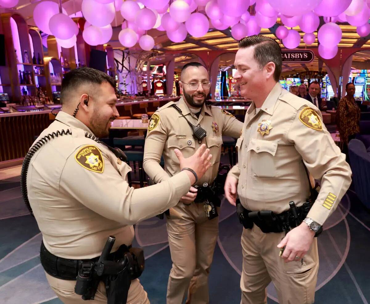 Los agentes de policía de Las Vegas Humberto Zarate, izquierda, y Oscar Murguia, centro, son s ...