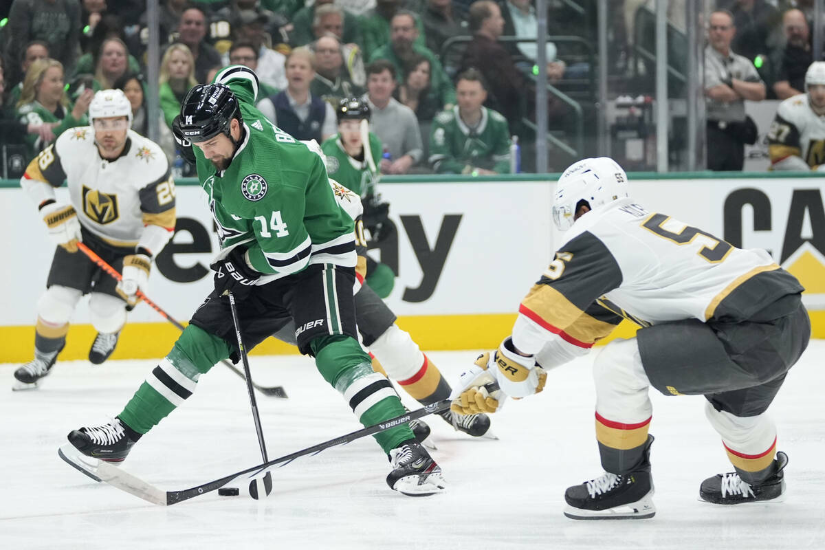 El ala izquierda Jamie Benn (14) de los Dallas Stars controla el puck frente al ala derecha de ...