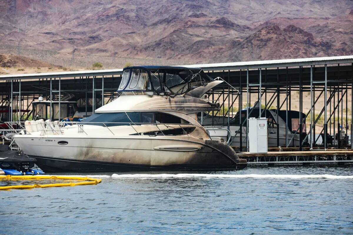 Un barco dañado en la escena donde un incendio hundió 10 barcos, hizo daño a varios más y c ...