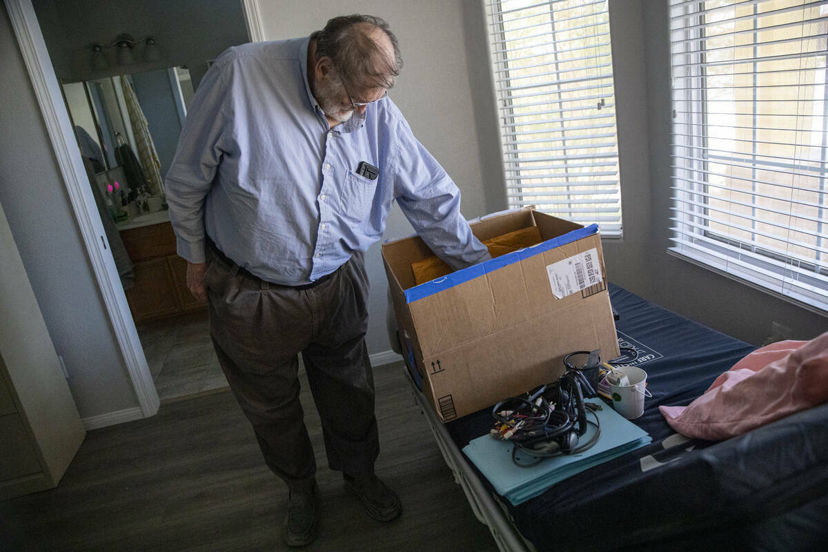 James Belnap, el viudo de Marsha Belnap, revisa el contenido de una caja encima de la cama méd ...