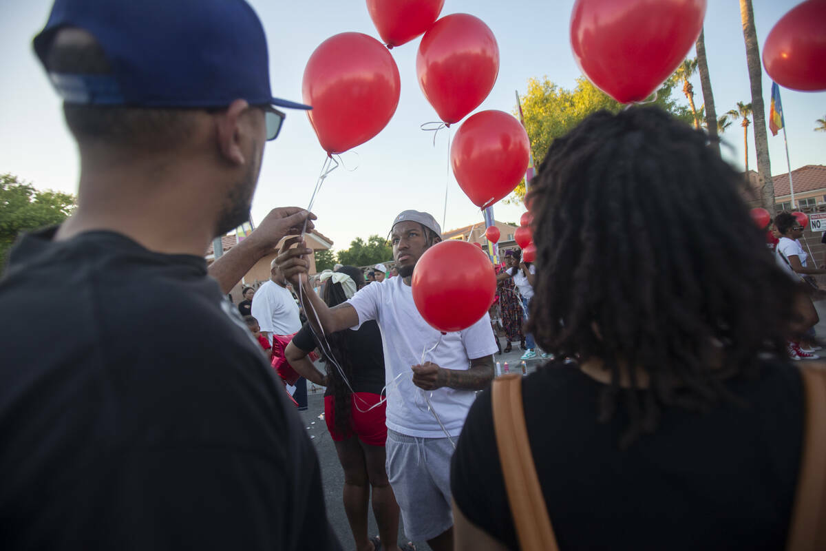 Globos rojos se reparten durante una vigilia por Kayla Harris en Craig Ranch Villas, el miérco ...