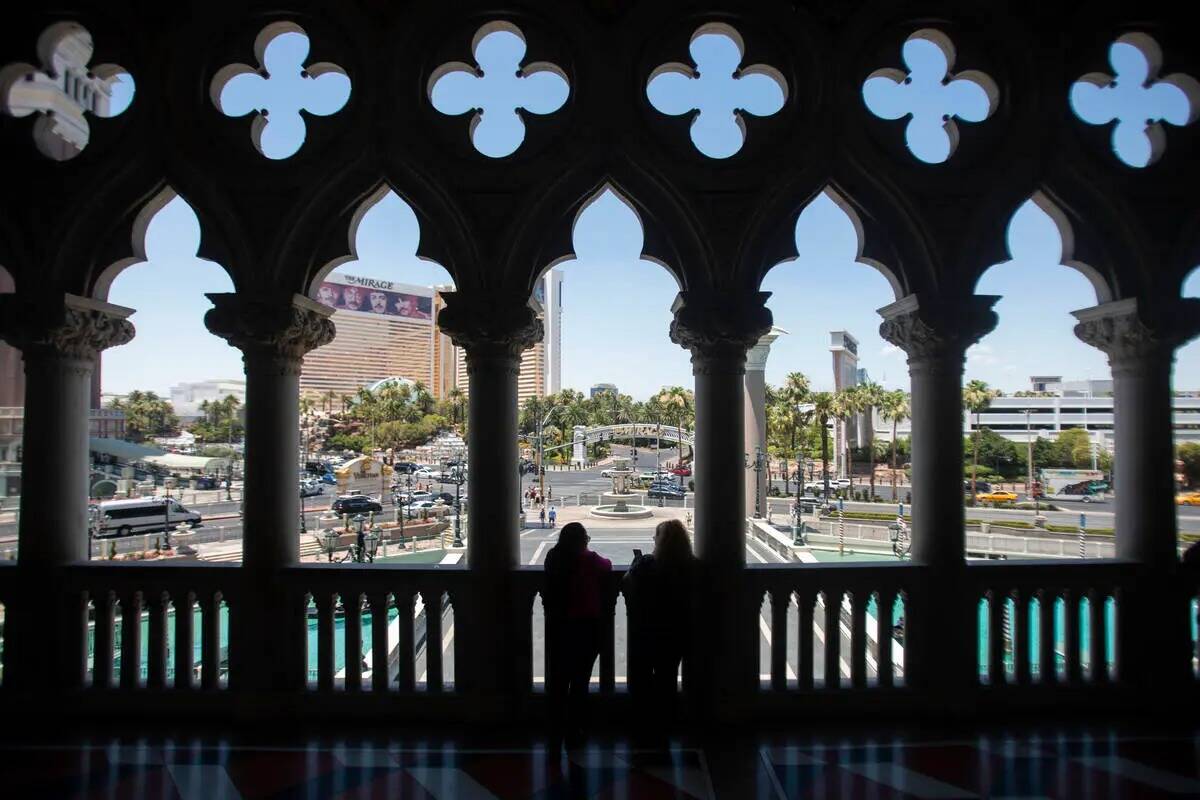 Un grupo de turistas mira hacia el Strip desde The Venetian, el jueves 27 de junio de 2024, en ...