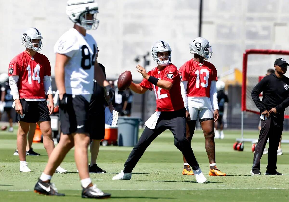 El quarterback de los Raiders Aidan O'Connell (12) se prepara para lanzar el balón mientras lo ...