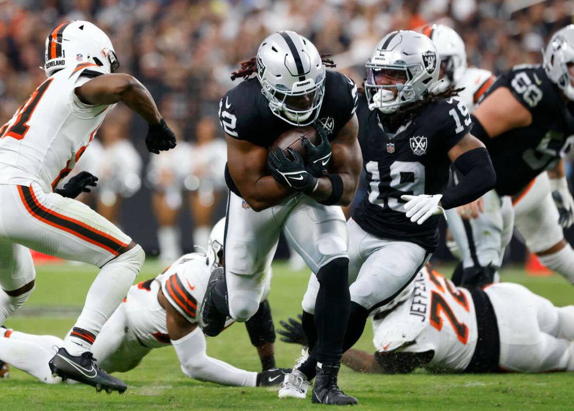 El running back de los Raiders Alexander Mattison (22) corre ante el defensivo de los Cleveland ...