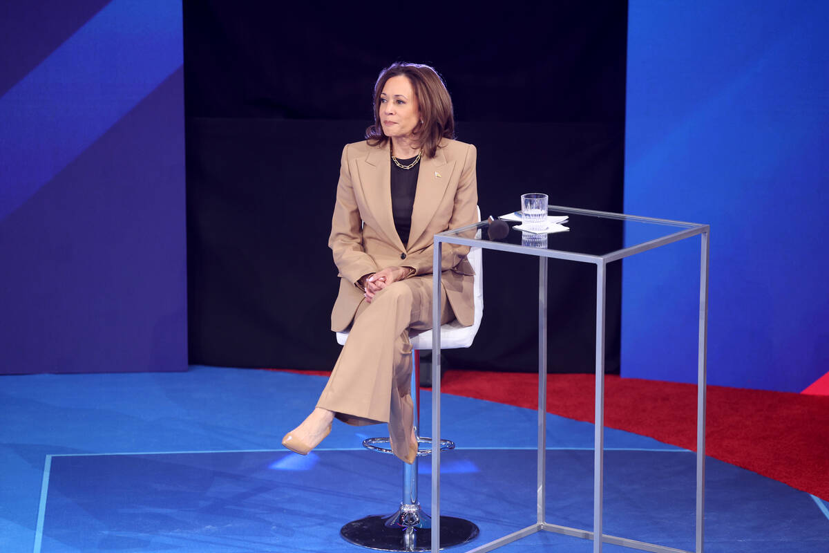 Vice President Kamala Harris takes a seat during a commercial break while engaging with Latino ...