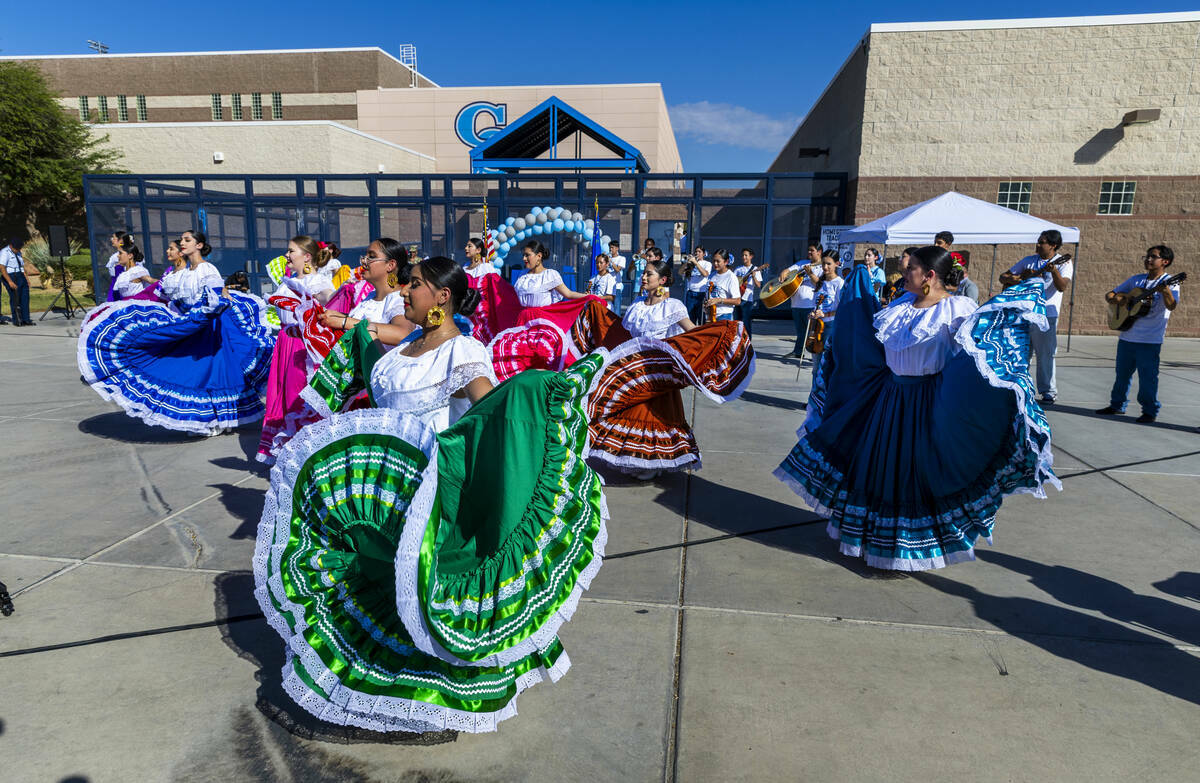 Bailarines folclóricos estudiantiles respaldados por una banda de mariachis se presentan en el ...