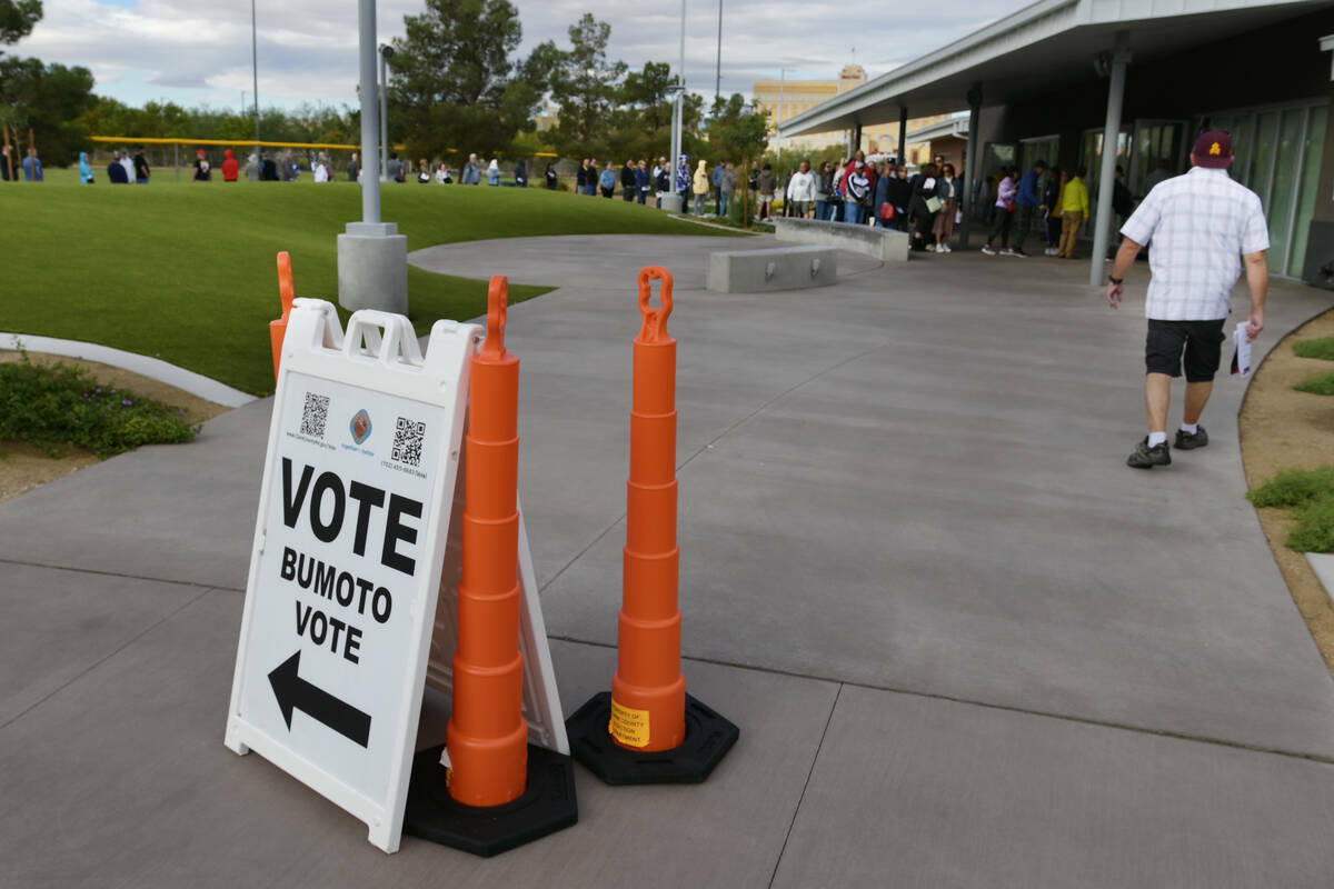 Electores hacen fila afuera del Silverado Ranch Community Center para participar en la votació ...